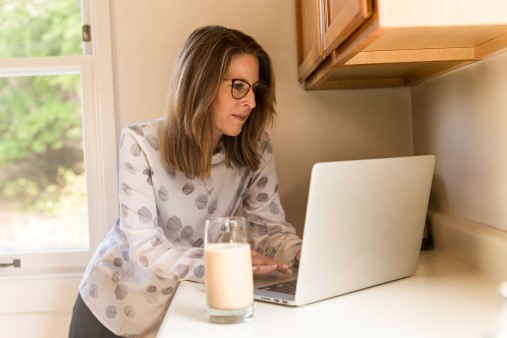 Woman sitting at laptop working in the gig economy from home