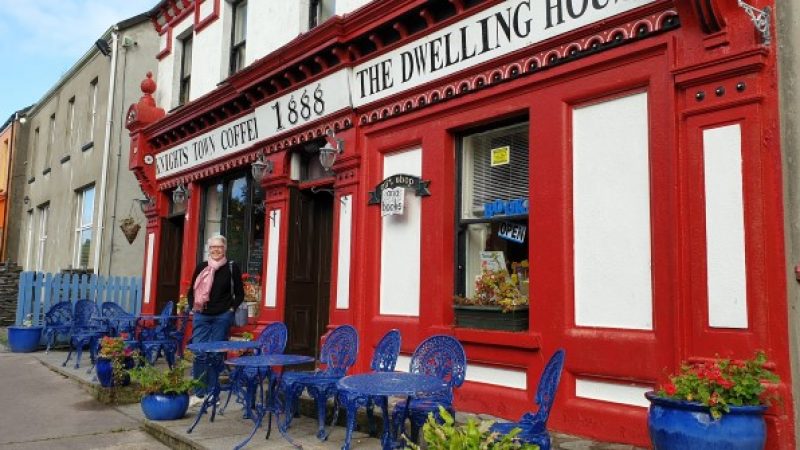 The Dwelling House Coffee shop with a woman standing outside