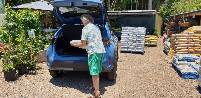 Man loading soil into the boot of a Toyota Yaris Cross SUV from Ken Mills Toyota