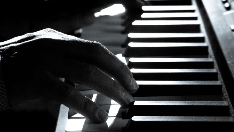 male hands on piano keyboard
