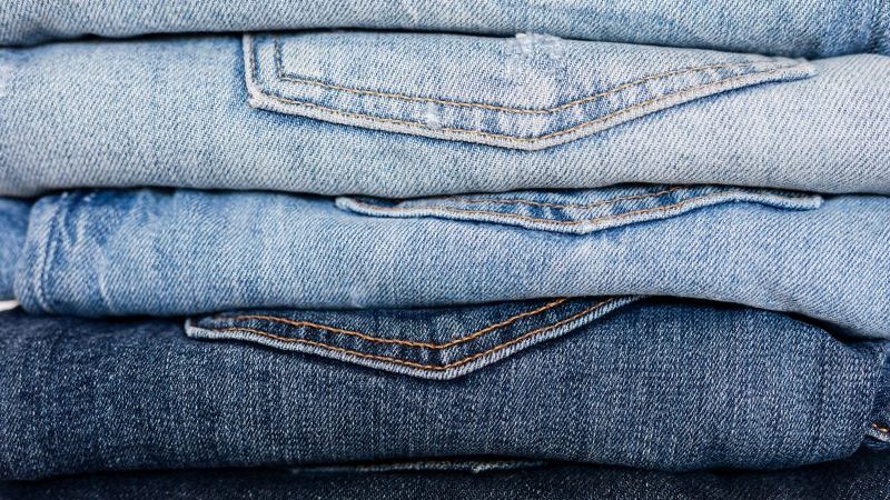a stack of denim jeans