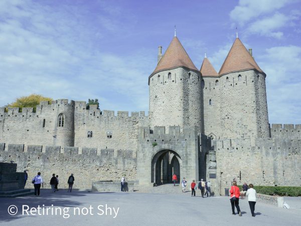 High walls and towers with an archway into the walled City of Carcassonne