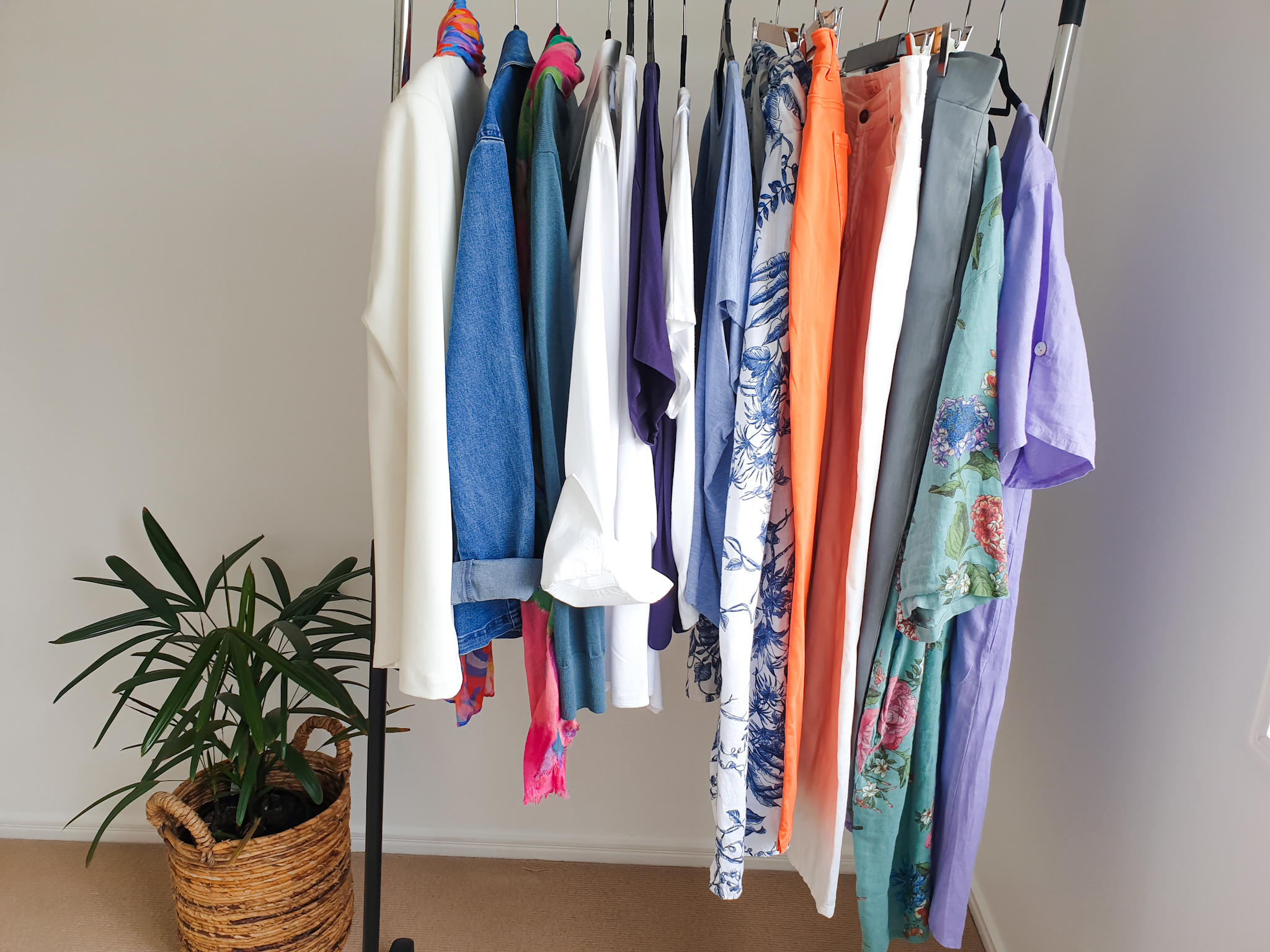 a rack of clothes that form a spring capsule wardrobe