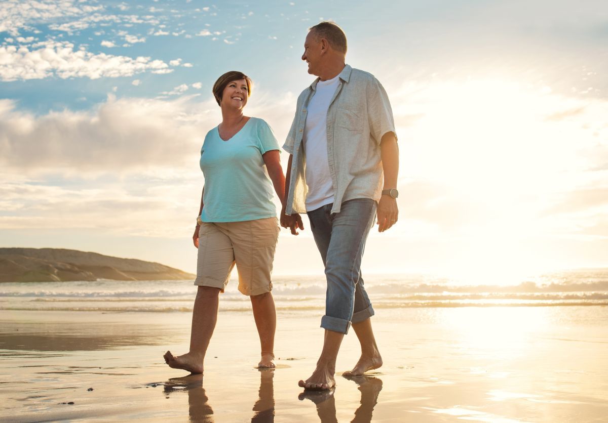 Couple exploring the beach on a morning walk on their capricorn coast caravanning adventure